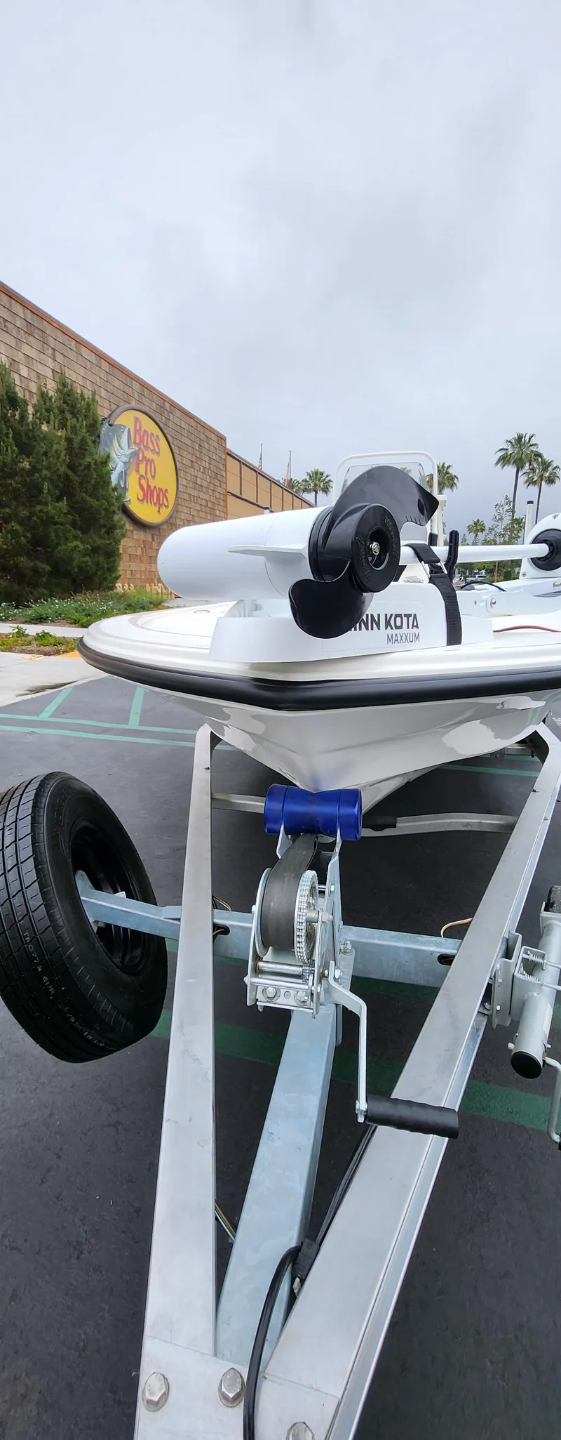 Slide: The Image of 2025 Mako 18 LTS boat on trailer outside Bass Pro Shops. - 3
