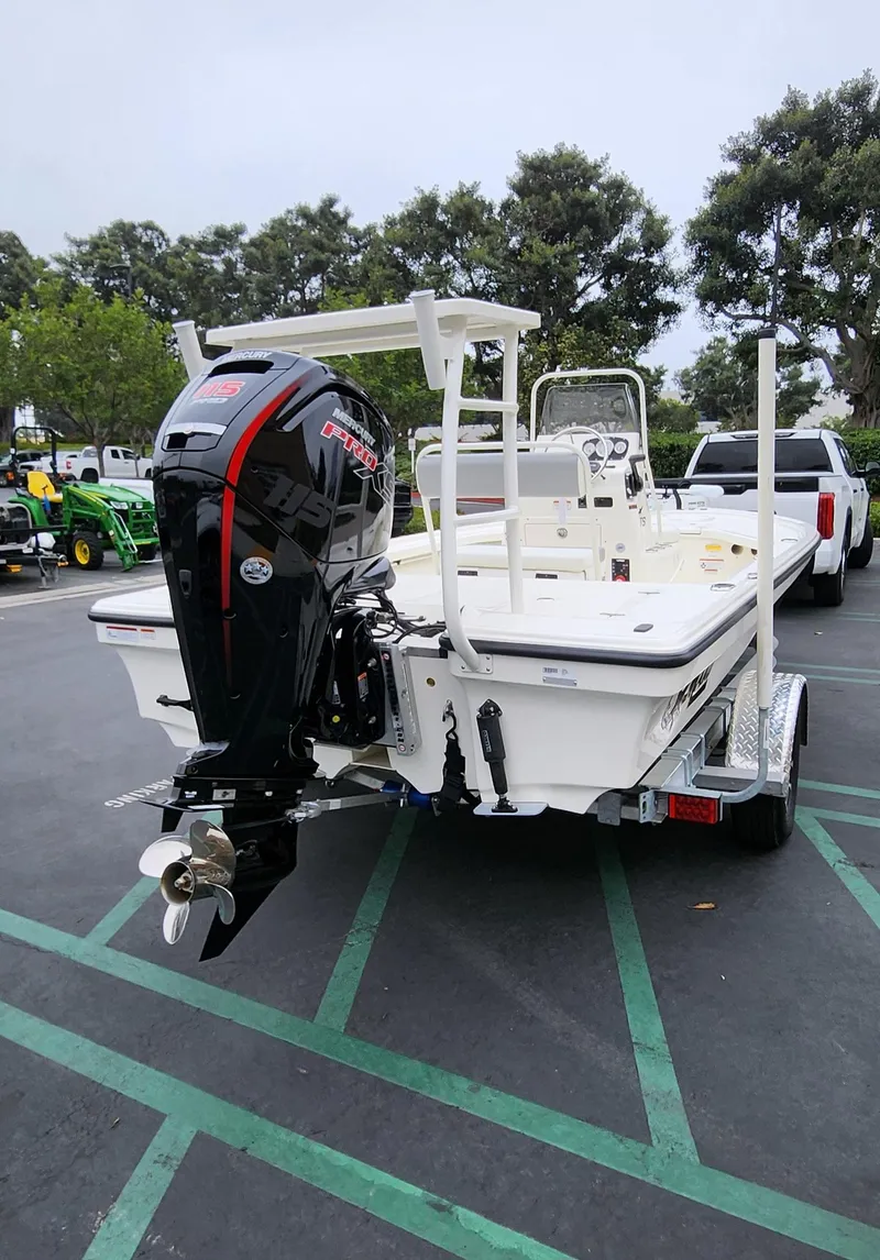 Slide: The Image of 2025 Mako 18 LTS boat with outboard motor in parking lot. - 6