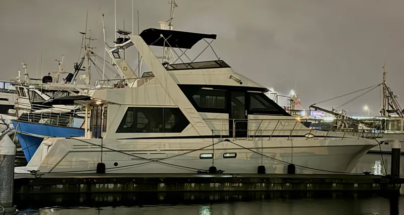Slide: The Image of 1993 Navigator 5000 Classic yacht docked at night, illuminated by harbor lights. - 0