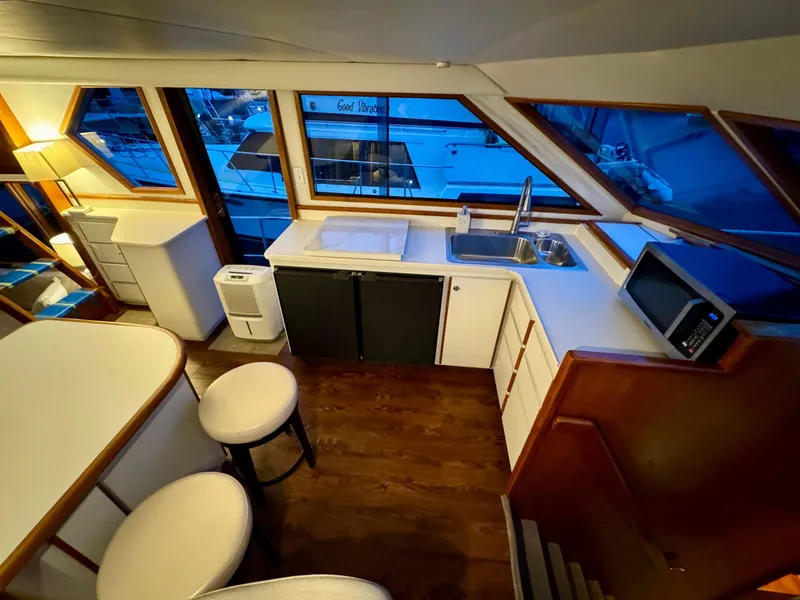Slide: The Image of Interior of 1993 Navigator 5000 Classic yacht with modern kitchen and seating area. - 13