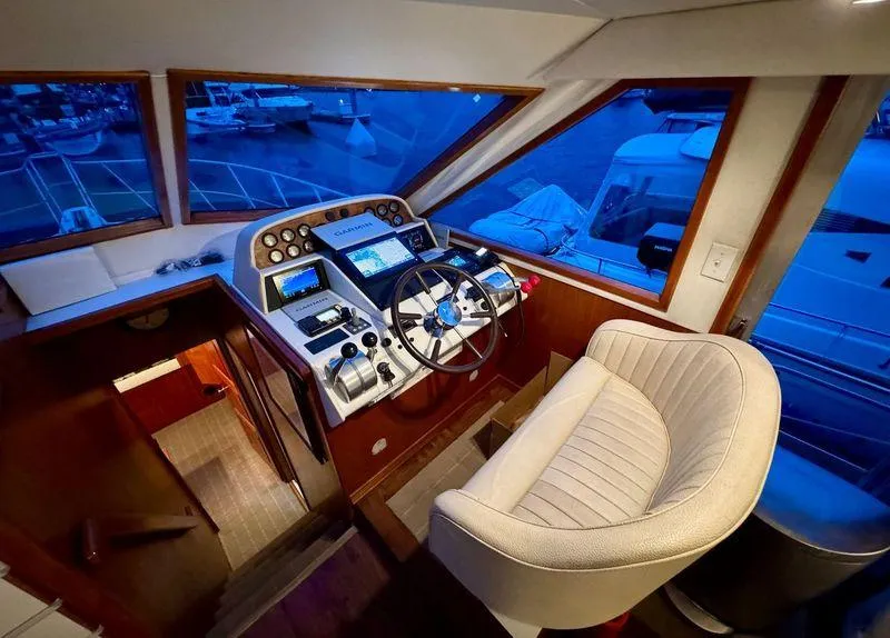 Slide: The Image of Cockpit of 1993 Navigator 5000 Classic yacht with steering wheel and navigation controls. - 18