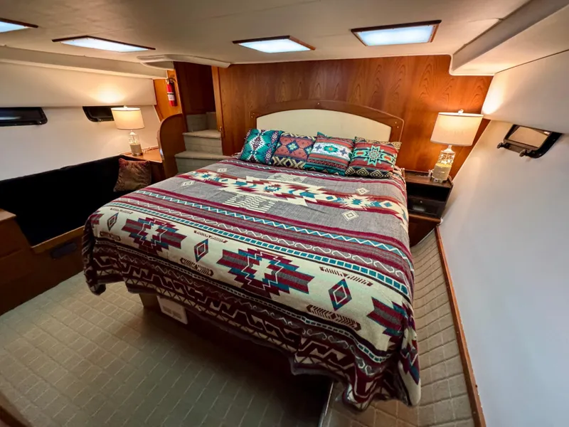 Slide: The Image of Luxurious bedroom in 1993 Navigator 5000 Classic yacht with patterned bedding and ambient lighting. - 22