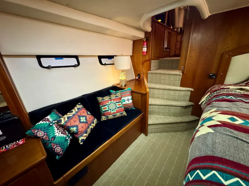 Slide: The Image of Cozy 1993 Navigator 5000 Classic yacht interior with patterned cushions and elegant wooden stairs. - 25