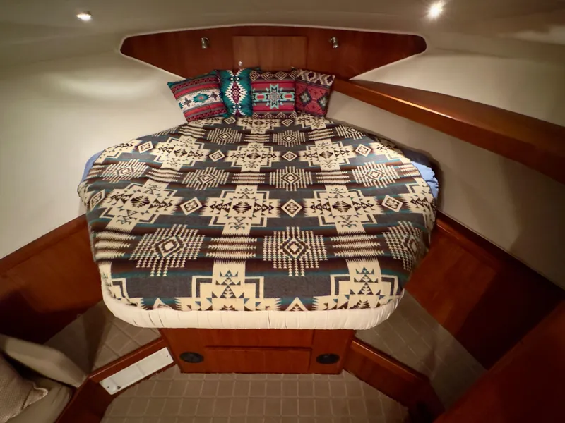 Slide: The Image of Cozy cabin bed in 1993 Navigator 5000 Classic yacht with patterned bedding and pillows. - 27