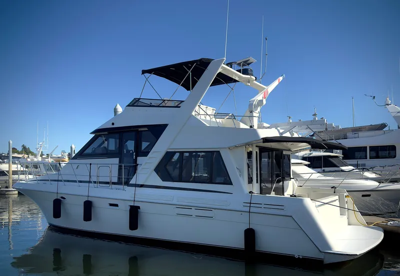 Slide: The Image of 1993 Navigator 5000 Classic yacht docked at marina under clear blue sky. - 3