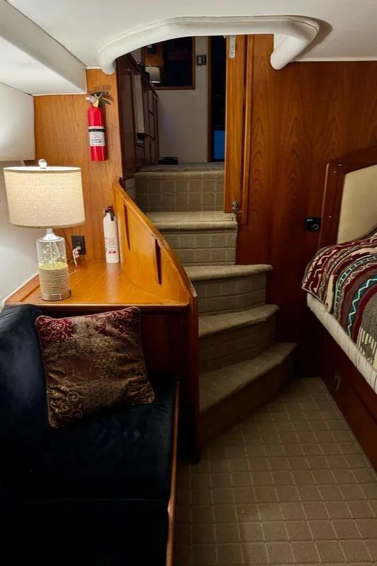 Slide: The Image of Interior of a 1993 Navigator 5000 Classic yacht with cozy seating and wooden stairs. - 37
