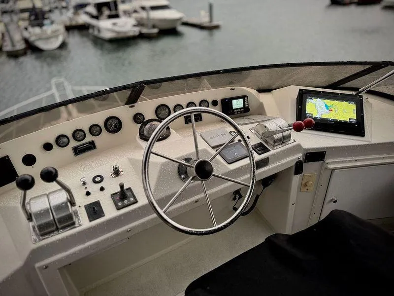Slide: The Image of Cockpit of 1993 Navigator 5000 Classic yacht with steering wheel and navigation controls. - 38