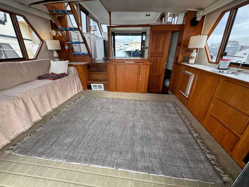 Slide: The Image of Spacious interior of 1993 Navigator 5000 Classic yacht with wooden cabinetry and cozy seating. - 4