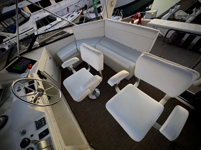 Slide: The Image of Interior of 1993 Navigator 5000 Classic yacht with white seating and steering wheel. - 42