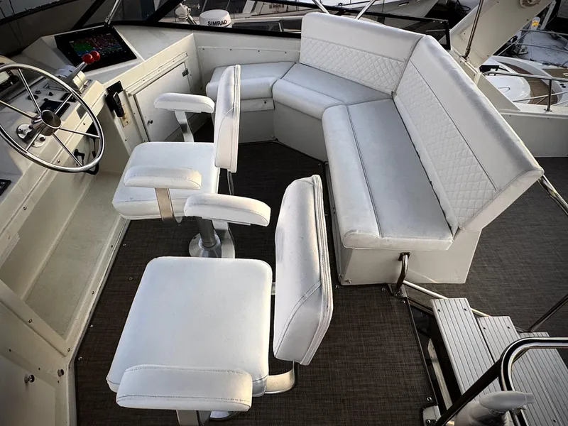 Slide: The Image of 1993 Navigator 5000 Classic boat interior with white seating and steering wheel. - 43