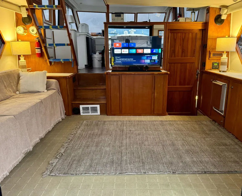 Slide: The Image of Interior of 1993 Navigator 5000 Classic yacht with cozy seating and modern TV setup. - 5