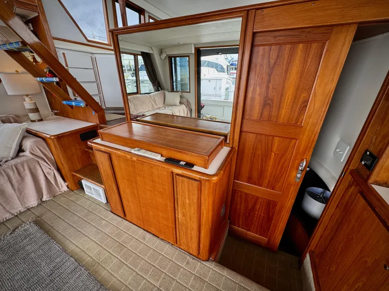 Slide: The Image of Interior of 1993 Navigator 5000 Classic yacht with wooden cabinetry and cozy seating area. - 6