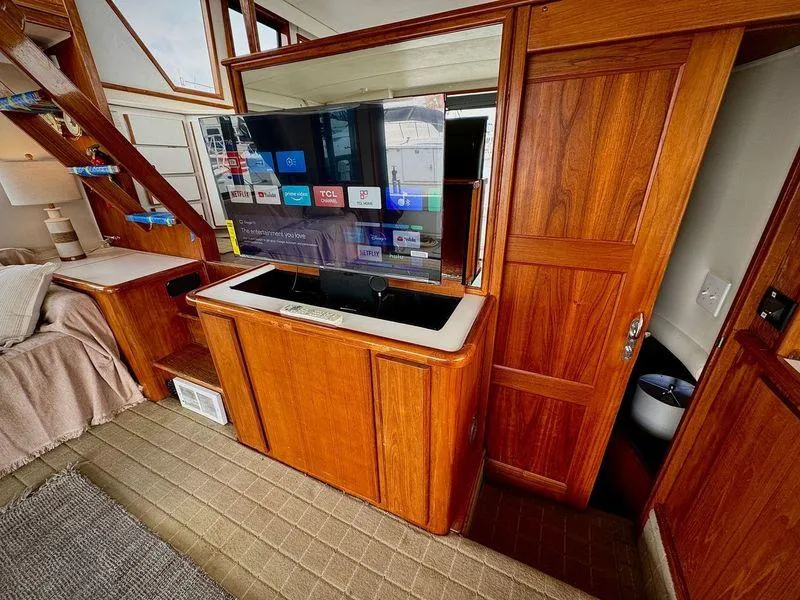 Slide: The Image of Interior of 1993 Navigator 5000 Classic with wood paneling and modern TV setup. - 7