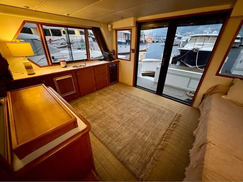 Slide: The Image of Interior of 1993 Navigator 5000 Classic yacht with cozy seating and marina view. - 9