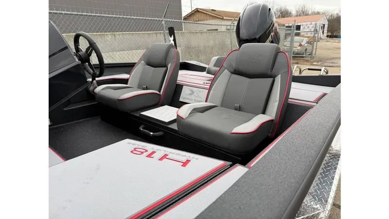 Slide: The Image of 2025 Xpress H18 boat interior with dual gray seats and red accents. - 4