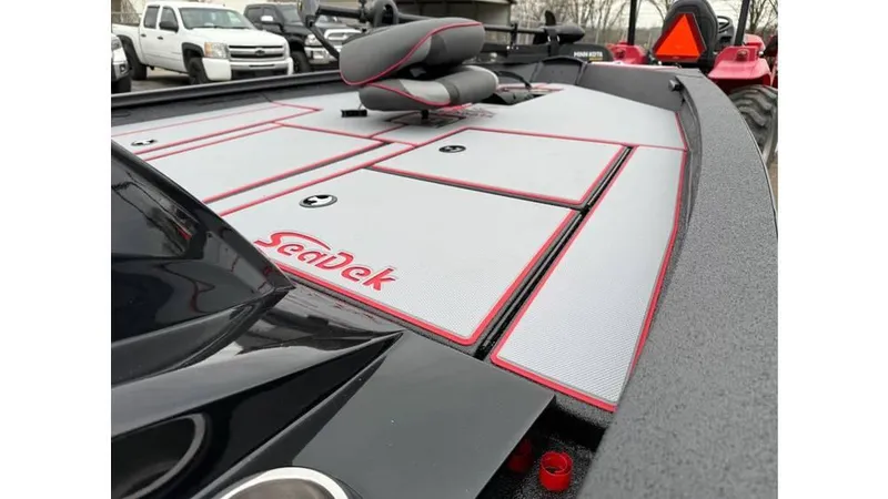 Slide: The Image of 2025 Xpress H18 boat deck with SeaDek flooring, featuring red accents and storage compartments. - 7