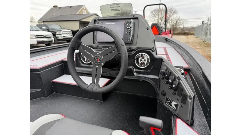 Slide: The Image of 2025 Xpress H18 boat cockpit with steering wheel, control panel, and navigation display. - 8