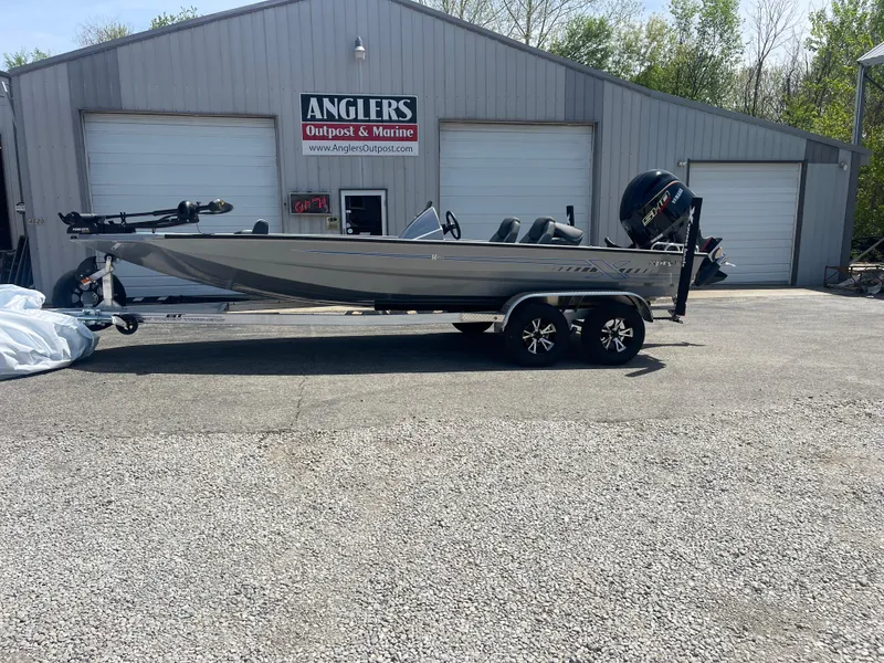 Slide: The Image of 2025 Xpress H20 boat on trailer outside Anglers Outpost & Marine building. - 2