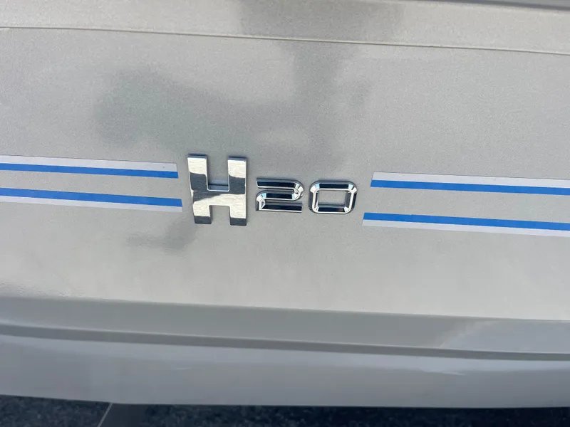 Slide: The Image of 2025 Xpress H20 emblem on a silver vehicle with blue stripes. - 6