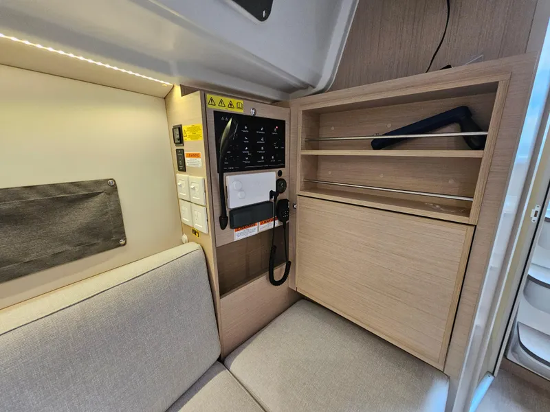 Slide: The Image of Interior of 2022 Beneteau Oceanis 30.1 yacht with seating and storage. - 13