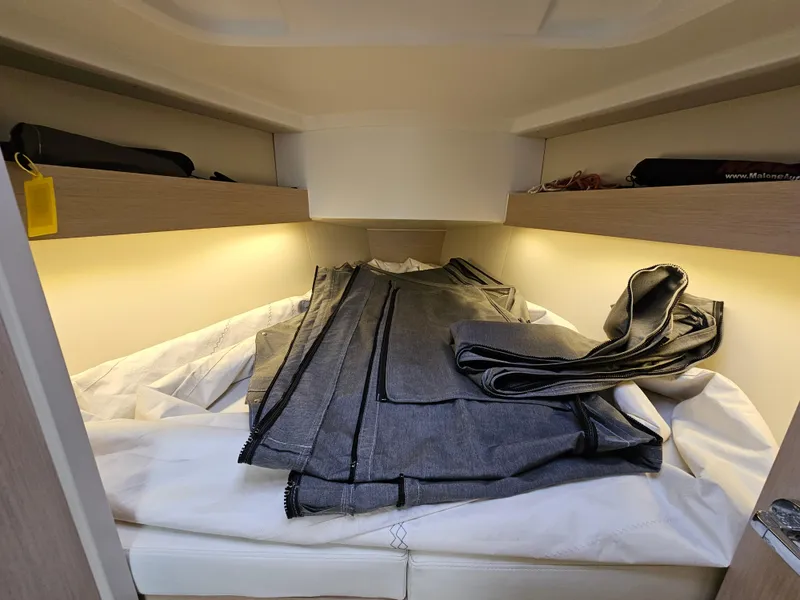 Slide: The Image of Interior cabin of 2022 Beneteau Oceanis 30.1 yacht with storage shelves and bedding. - 15