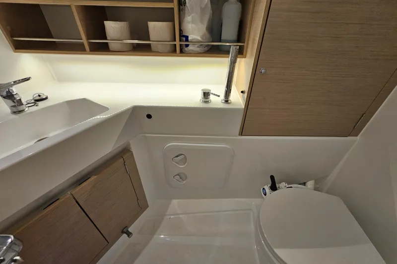 Slide: The Image of Modern bathroom in 2022 Beneteau Oceanis 30.1 yacht, featuring sink and toilet. - 17