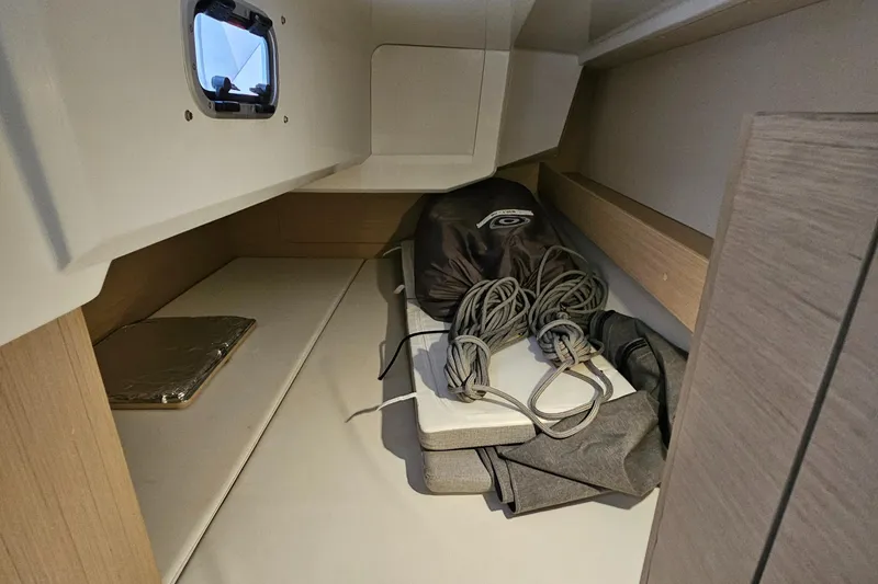 Slide: The Image of Interior storage space of 2022 Beneteau Oceanis 30.1 sailboat with ropes and equipment. - 18