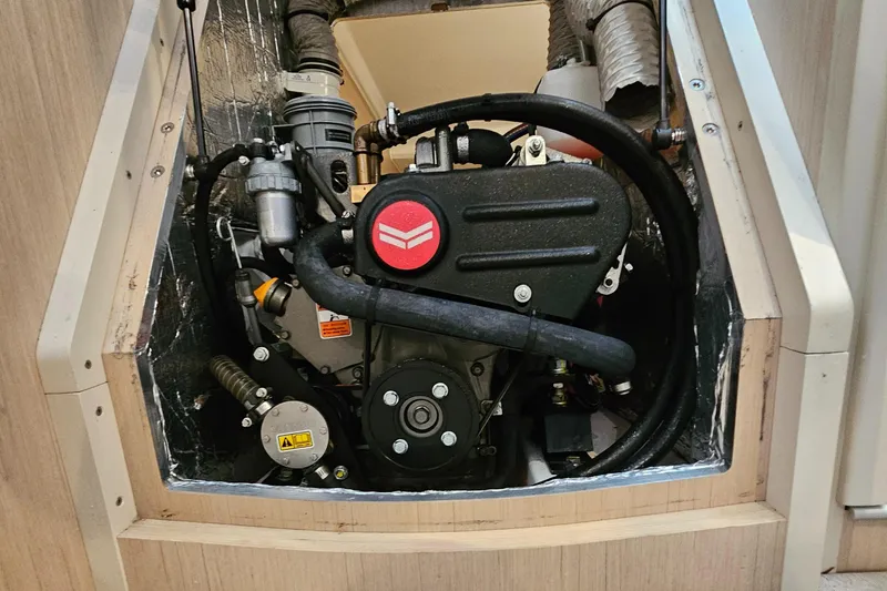 Slide: The Image of Engine compartment of a 2022 Beneteau Oceanis 30.1 sailboat, showcasing mechanical components. - 19