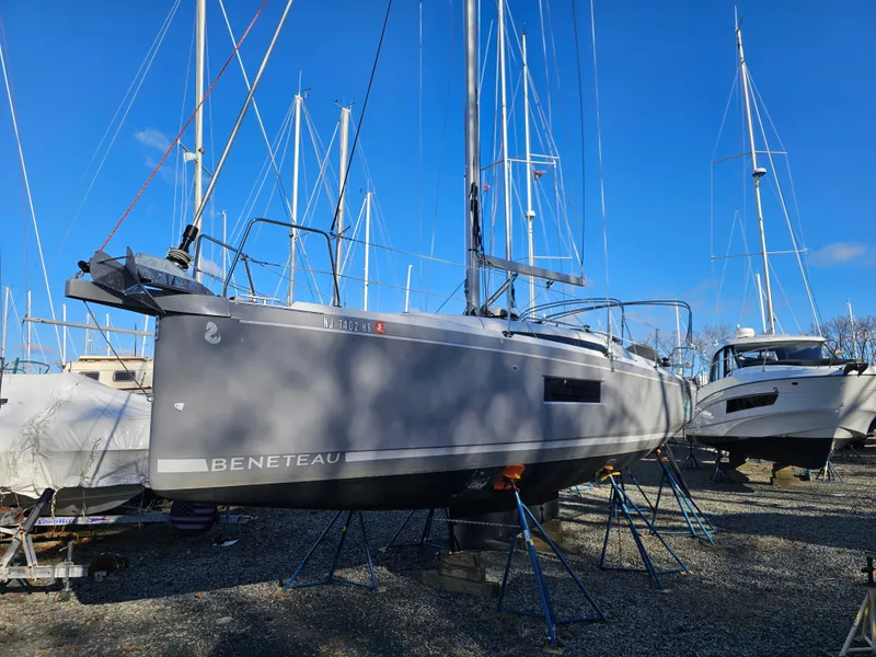 Slide: The Image of Beneteau Oceanis 30.1 sailboat, 2022 model, on stands in a marina under clear blue sky. - 6