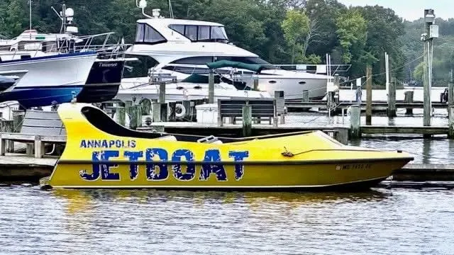 Slide: The Image of Yellow Annapolis jetboat docked, Smoky Mountain SMJB 21 model, 2014, with other boats in background. - 1