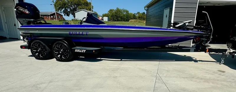 Slide: The Image of 2025 Bullet 21XST boat on trailer, sleek design, vibrant colors, parked outdoors. - 1