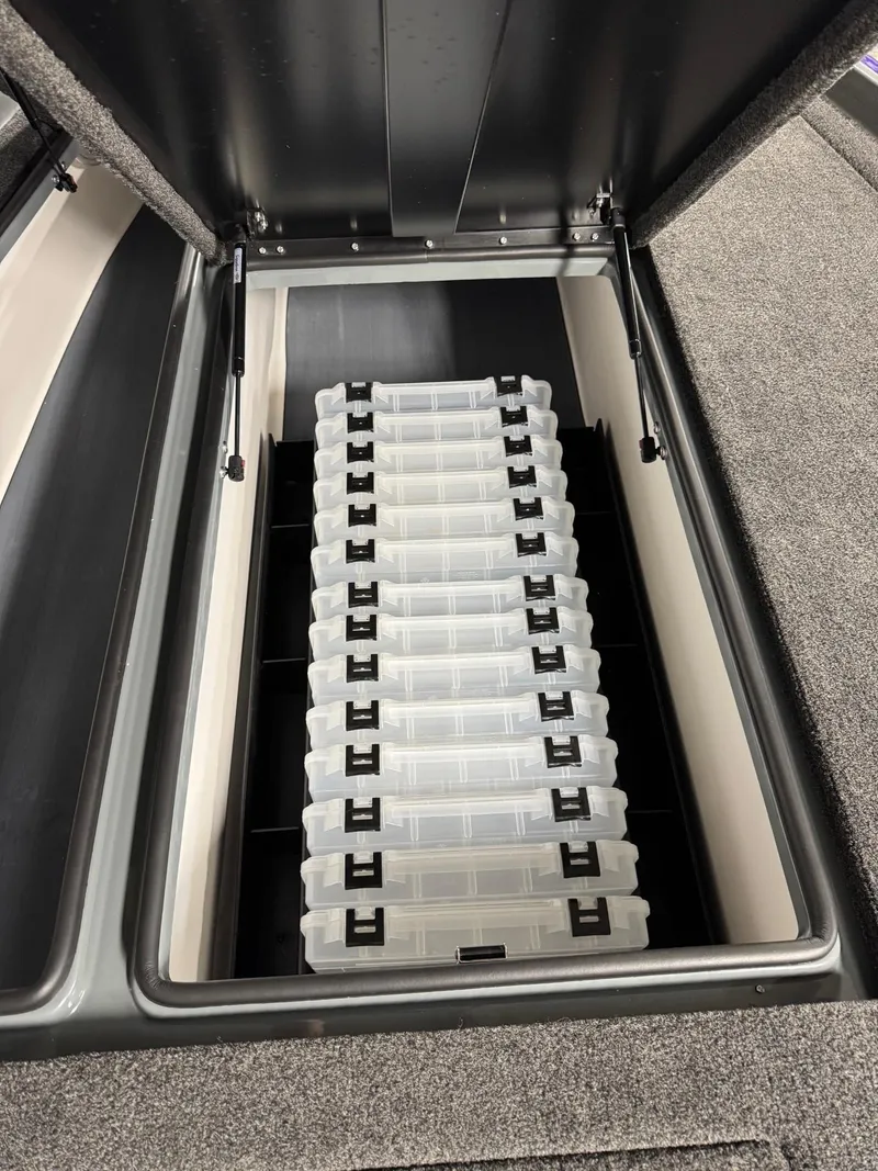 Slide: The Image of Storage compartment in 2025 Bullet 21XST boat with organized tackle boxes. - 10