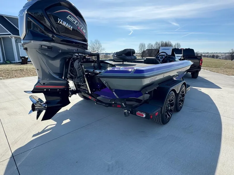 Slide: The Image of 2025 Bullet 21XST boat with Yamaha engine on a trailer in a driveway. - 13
