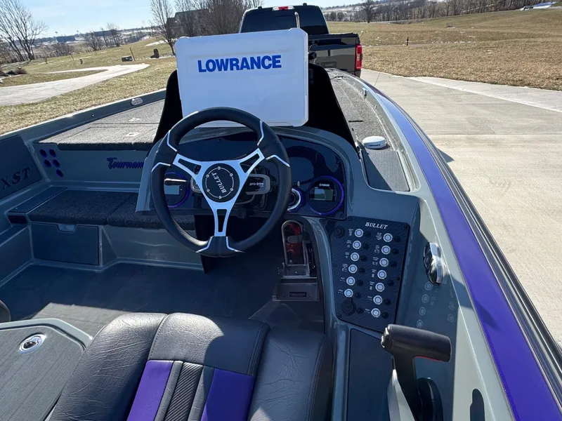 Slide: The Image of 2025 Bullet 21XST boat interior with steering wheel and Lowrance display. - 2
