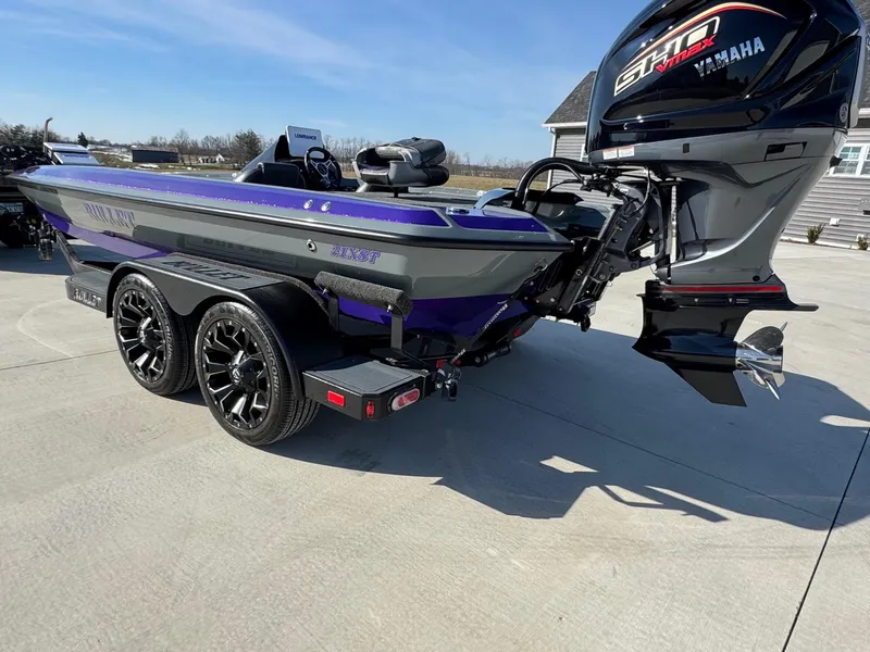 Slide: The Image of 2025 Bullet 21XST boat with Yamaha engine on a trailer, parked outdoors. - 3