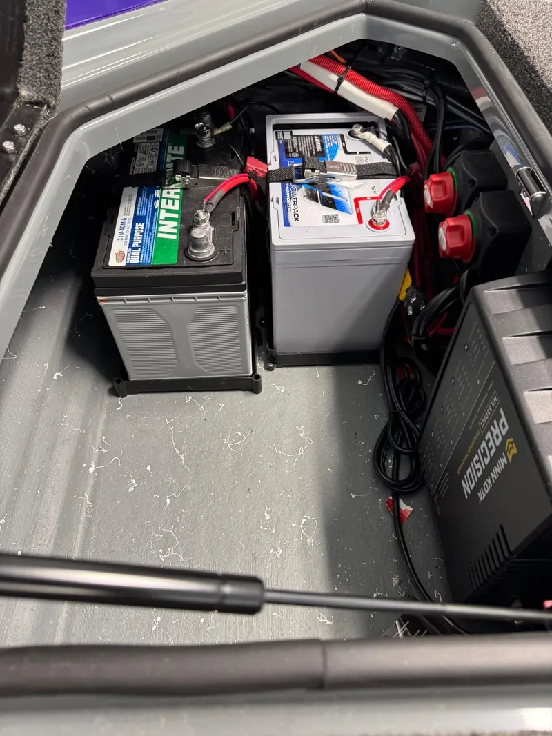 Slide: The Image of Battery compartment of 2025 Bullet 21XST boat with wiring and charger. - 7