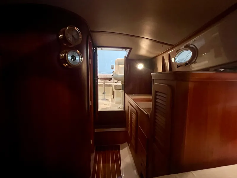 Slide: The Image of Interior of 2005 Hinckley Picnic Boat EP with wooden cabinetry and porthole windows. - 13