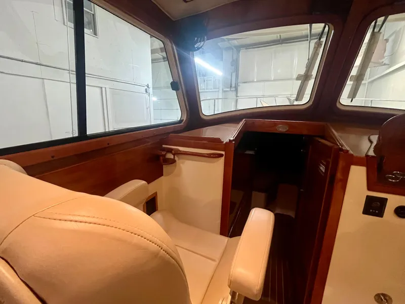 Slide: The Image of Interior of 2005 Hinckley Picnic Boat EP, featuring elegant wood and leather seating. - 14