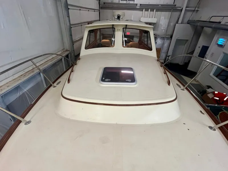 Slide: The Image of 2005 Hinckley Picnic Boat EP in storage, showcasing deck and cabin exterior. - 25