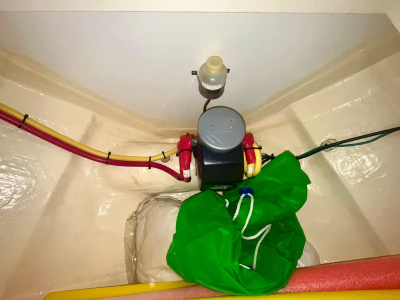 Slide: The Image of 2005 Hinckley Picnic Boat EP interior wiring and equipment with colorful cables and green bag. - 30