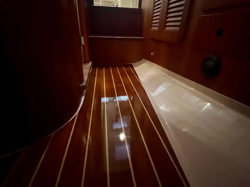 Slide: The Image of 2005 Hinckley Picnic Boat EP interior with polished wooden flooring and elegant design. - 34