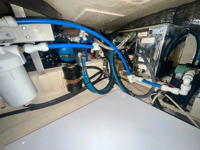 Slide: The Image of Engine compartment of a 2005 Hinckley Picnic Boat EP with visible wiring and components. - 35