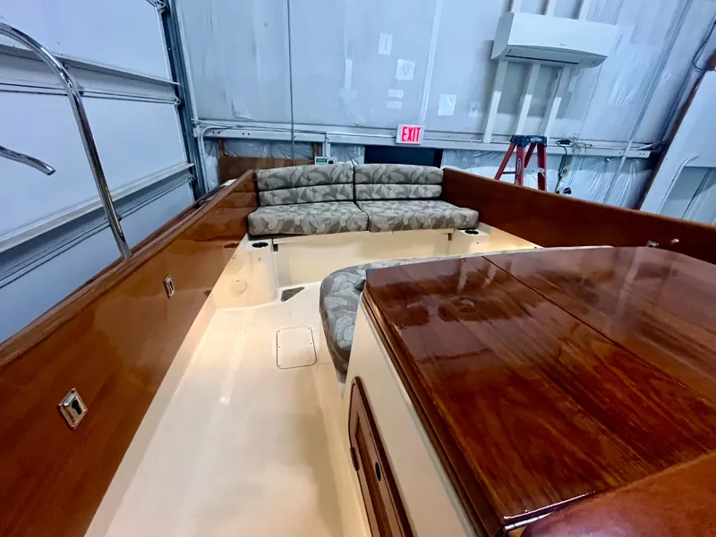 Slide: The Image of 2005 Hinckley Picnic Boat EP interior with wooden finish and cushioned seating. - 4