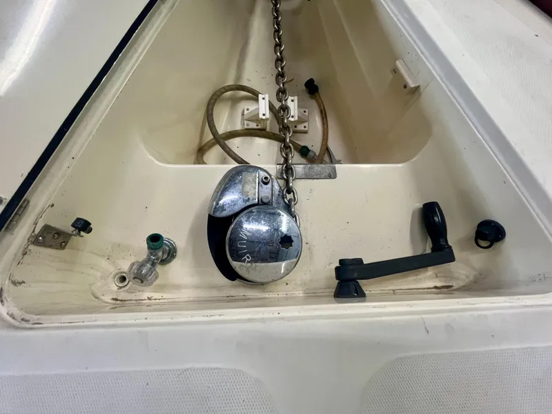 Slide: The Image of Anchor chain compartment of 2005 Hinckley Picnic Boat EP, featuring winch and handle. - 41