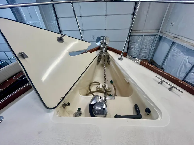 Slide: The Image of 2005 Hinckley Picnic Boat EP anchor locker with chain and winch in a garage setting. - 42