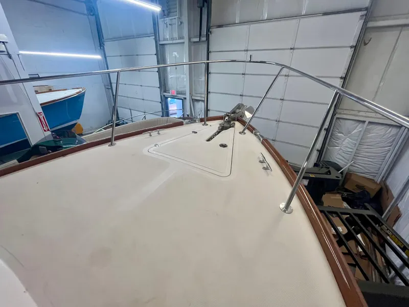 Slide: The Image of 2005 Hinckley Picnic Boat EP bow view in a storage facility. - 43