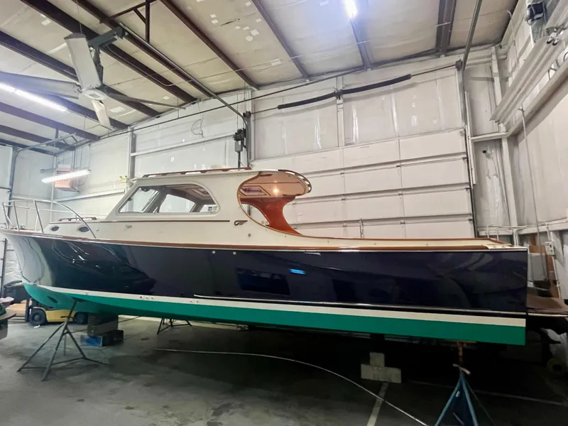 Slide: The Image of 2005 Hinckley Picnic Boat EP in a garage, showcasing elegant design and craftsmanship. - 45