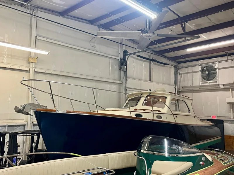 Slide: The Image of 2005 Hinckley Picnic Boat EP in a storage facility, showcasing classic design and craftsmanship. - 46