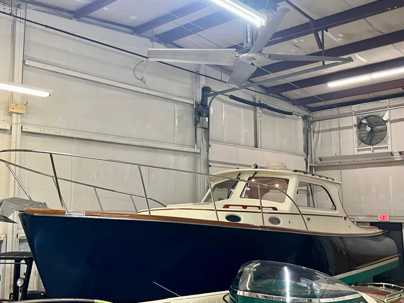 Slide: The Image of 2005 Hinckley Picnic Boat EP in a warehouse, showcasing classic design and elegant craftsmanship. - 47