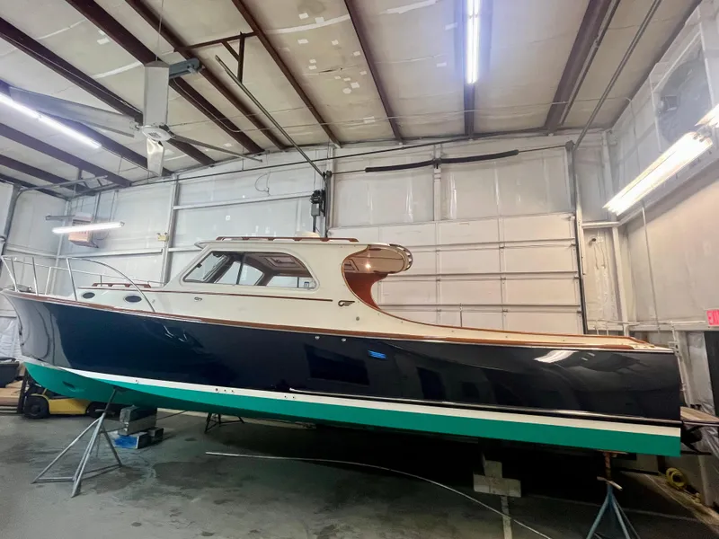 Slide: The Image of 2005 Hinckley Picnic Boat EP in a garage, showcasing sleek design and classic elegance. - 49